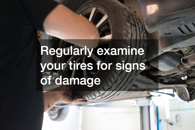 man inspecting a car tire